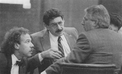 Joel Steinberg conferring with his attorneys. Steinberg was convicted of murdering 6-year-oid Lisa Steinberg whom he had illegally adopted (AP/Wide World Photos)