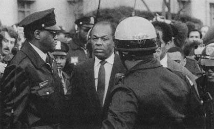 Mayor Marion Barry is escorted by police following his appearance before a federal magistrate. (AP/Wide World Photos)
