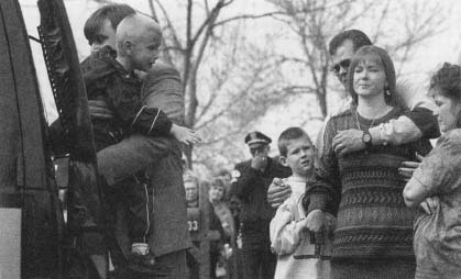 Otakar Kirchner (left) carries his son known as 'Baby Richard,' as the boy's foster family grieves. (AP/Wide World Photos)