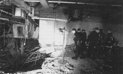 Police and firefighters inspect the bomb crater inside the World Trade Center. (AP/Wide World Photos)