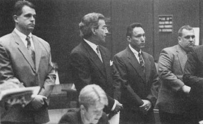 (Left to right) Officer Paul Harper, his lawyer Joel lsaacson, Sgt. Edward Ortiz, Sgt. Brian Liddy appearing in court for arraignment for their role in the Rampart Scandal. (The Gamma Liaison Network)