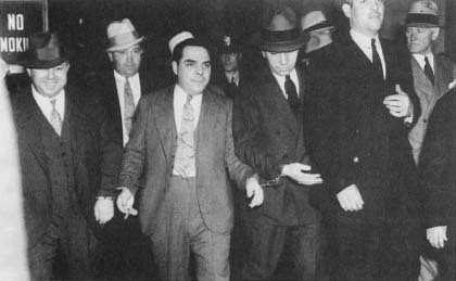 Lucky Luciano accompanied by guards at his hearing for compulsory prostitution, 1936. (AP/Wide World Photos)