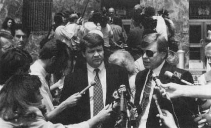 Laurence Powell with his attorney Michael Stone outside the courthouse, Stacey Koon in the background. (AP/Wide World Photos)